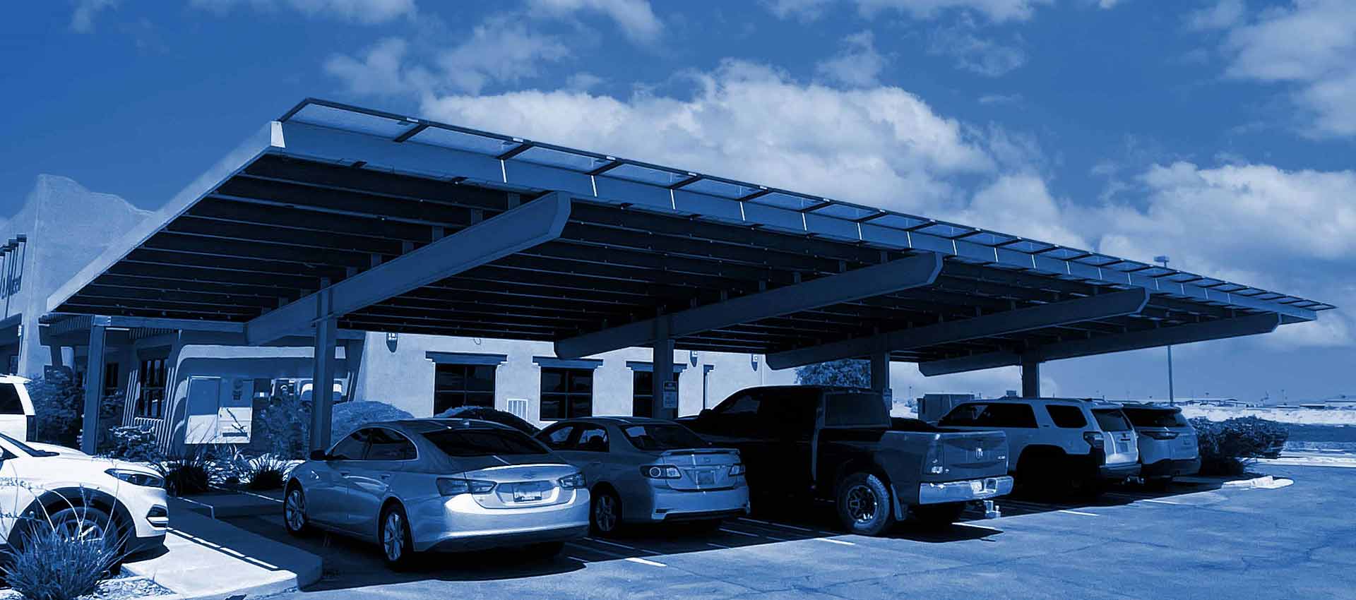 Wide angle shot of cars parked under a JRP Solar Shade Structure