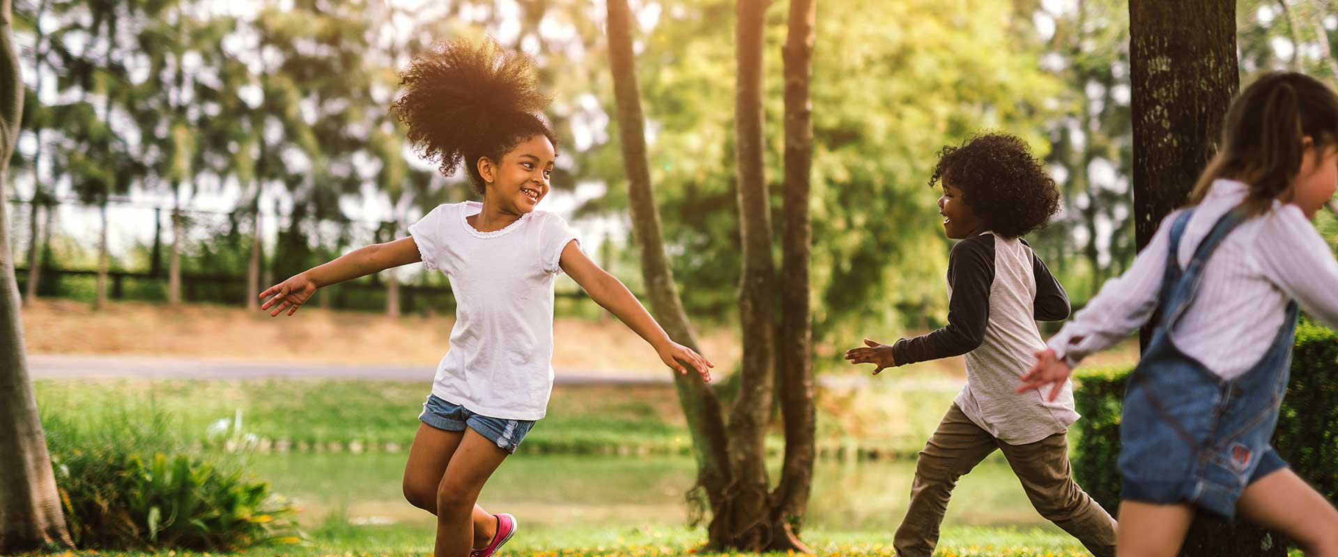 Be active! Children runnin around outdoors being active and having fun. Click on the button to learn more.