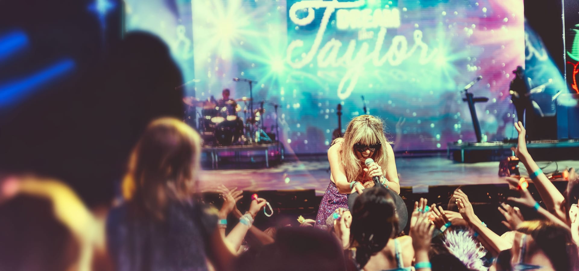 Cassie B performing in front of the crowd at a Dream Like Taylor event