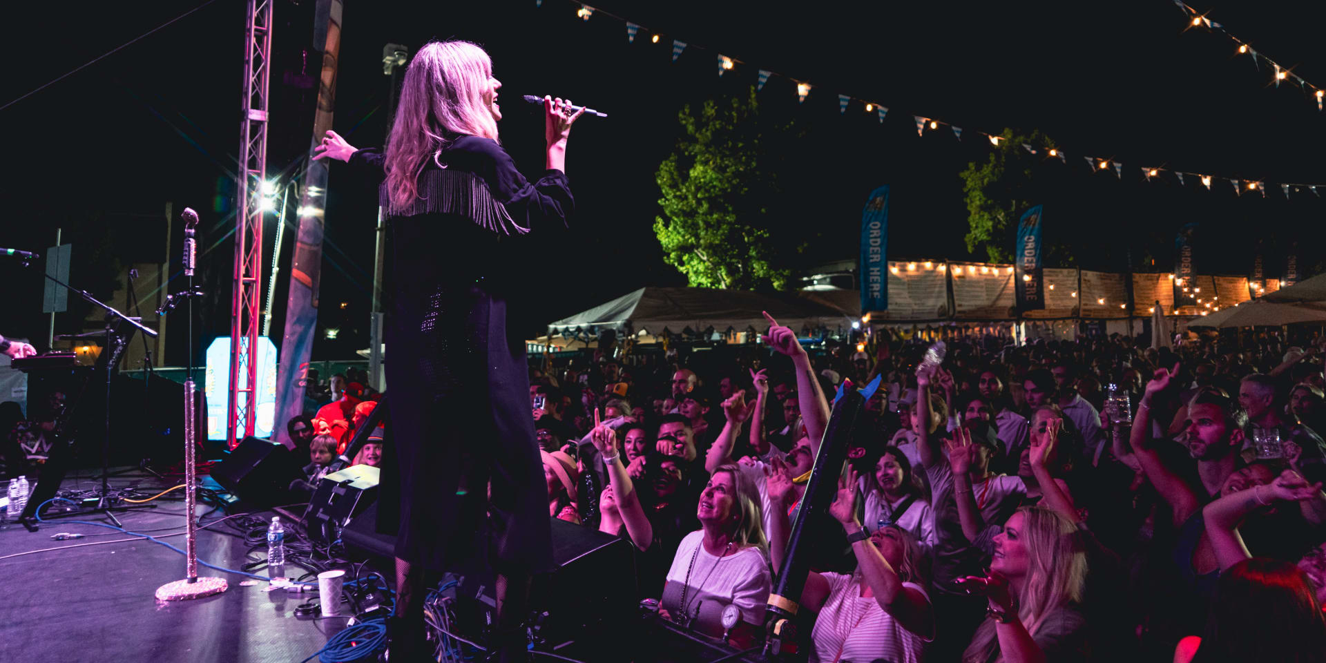 The crowd at a festival enjoying watching Cassie B perform