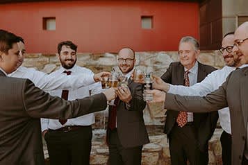 Men at a wedding share a toast