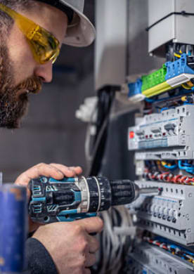 A technician working on industrial wiring