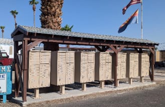 The US and AZ flags flying over the parks mailboxes at the entrance of the park