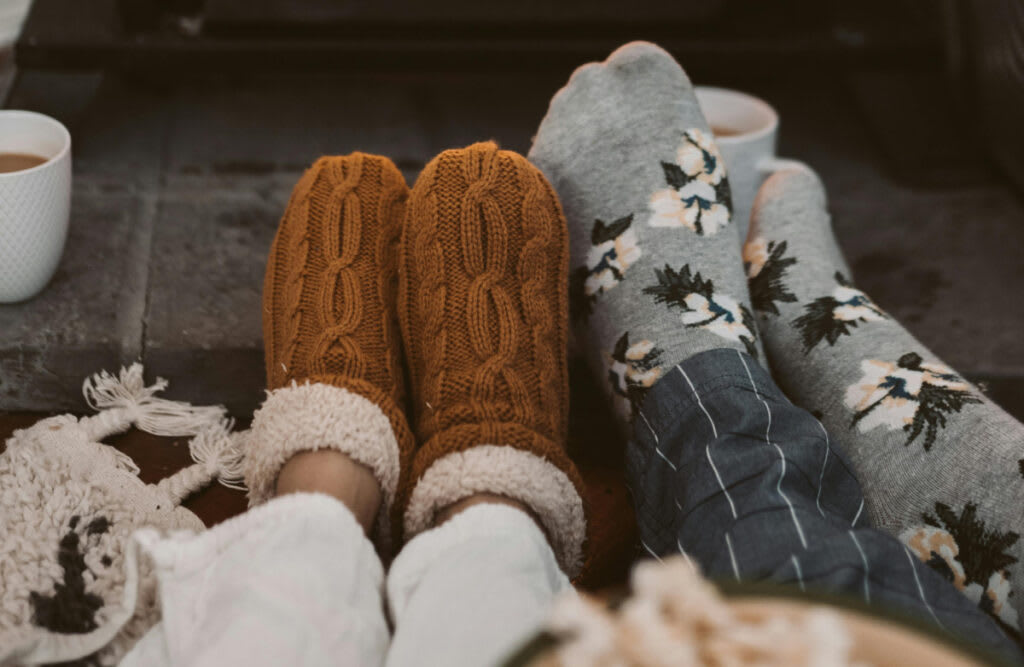 Couple in cozy slippers, capturing the warmth and comfort of a winter-ready home.