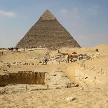 Egypts great pyramid in the background with excavations of other sites in the foreground