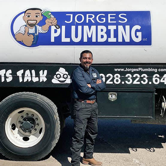 Jorge the owner, standing in front of a septic truck