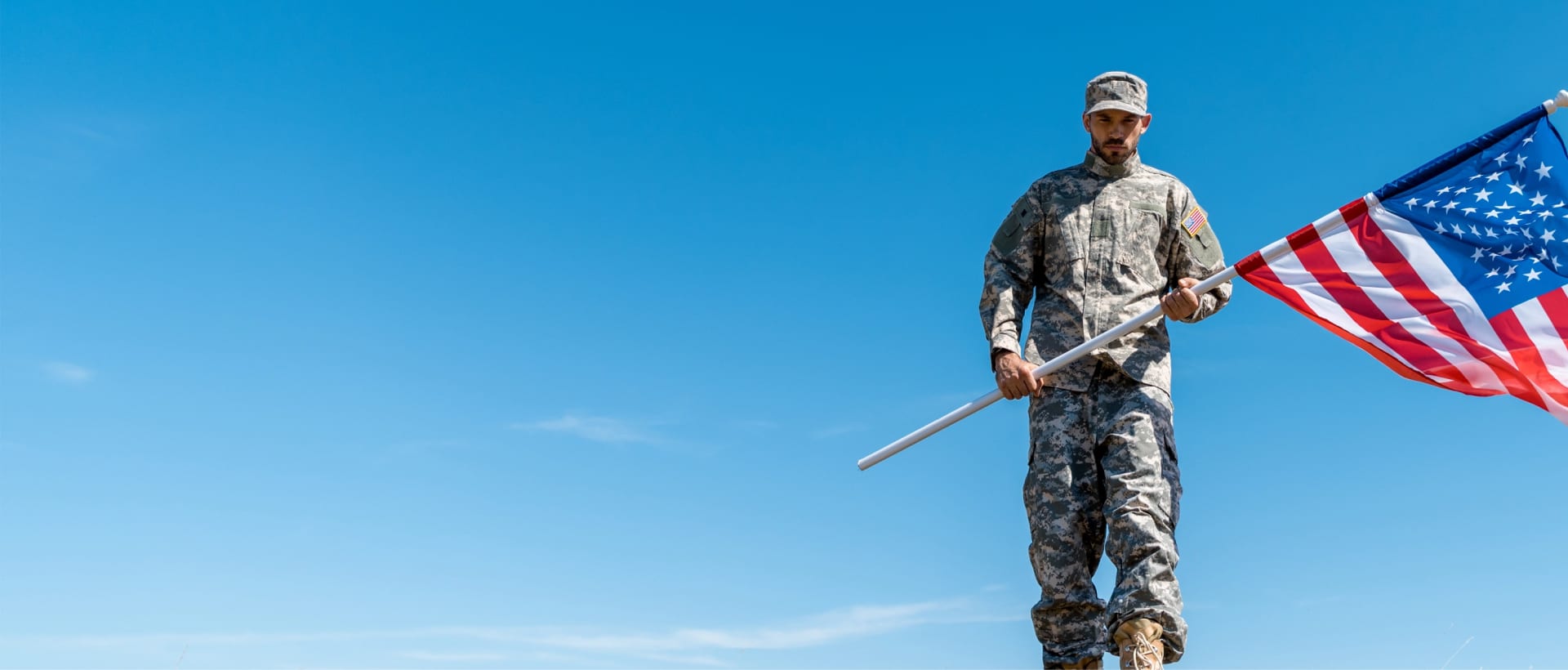 A member of the US military holding a US Flag