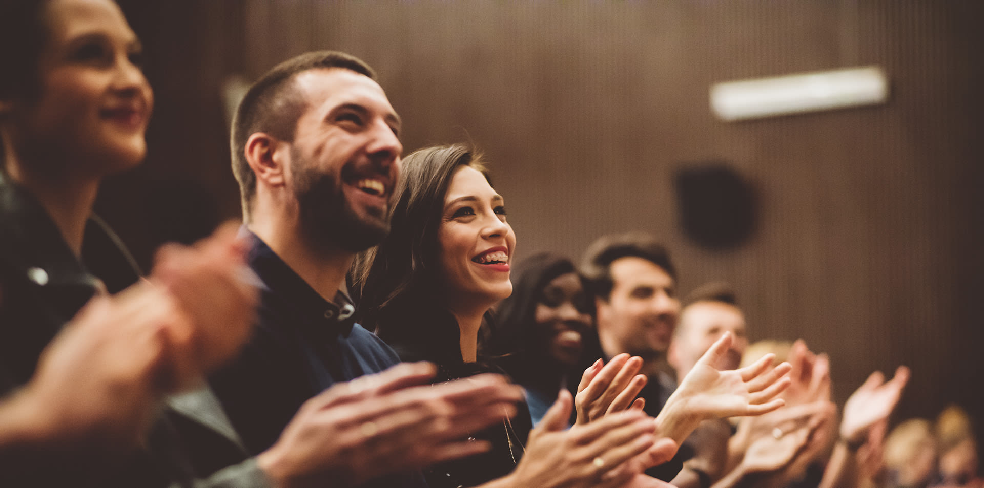 A crowd of happy laughing people in an auditorium