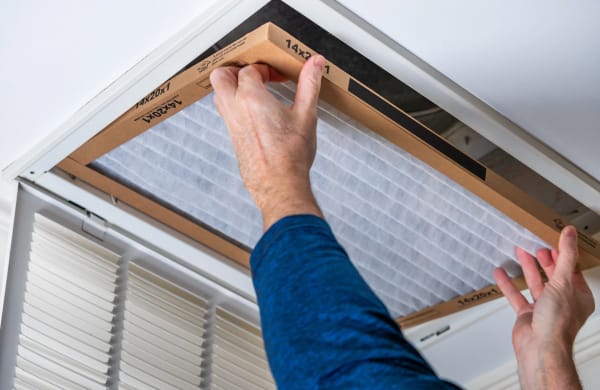 A residential air filter being installed.