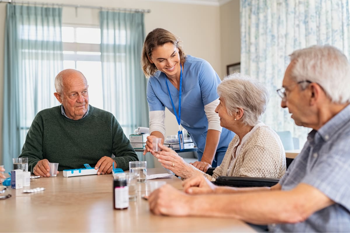 Senior citizens taking medications at an assisted living home