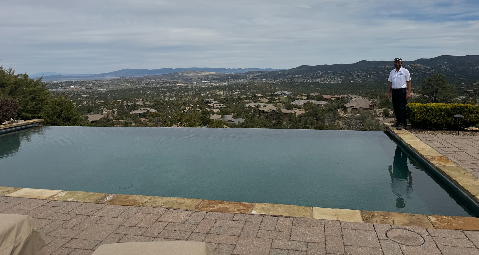 Bill standing at the edge of Client's infinity pool