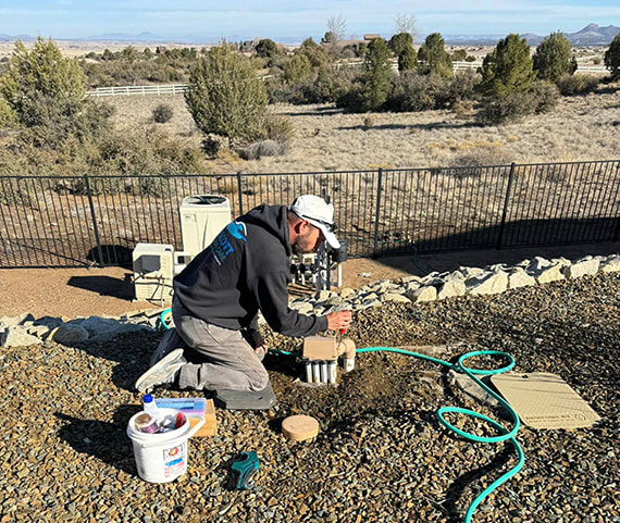 Employee fixing a pool in Prescott