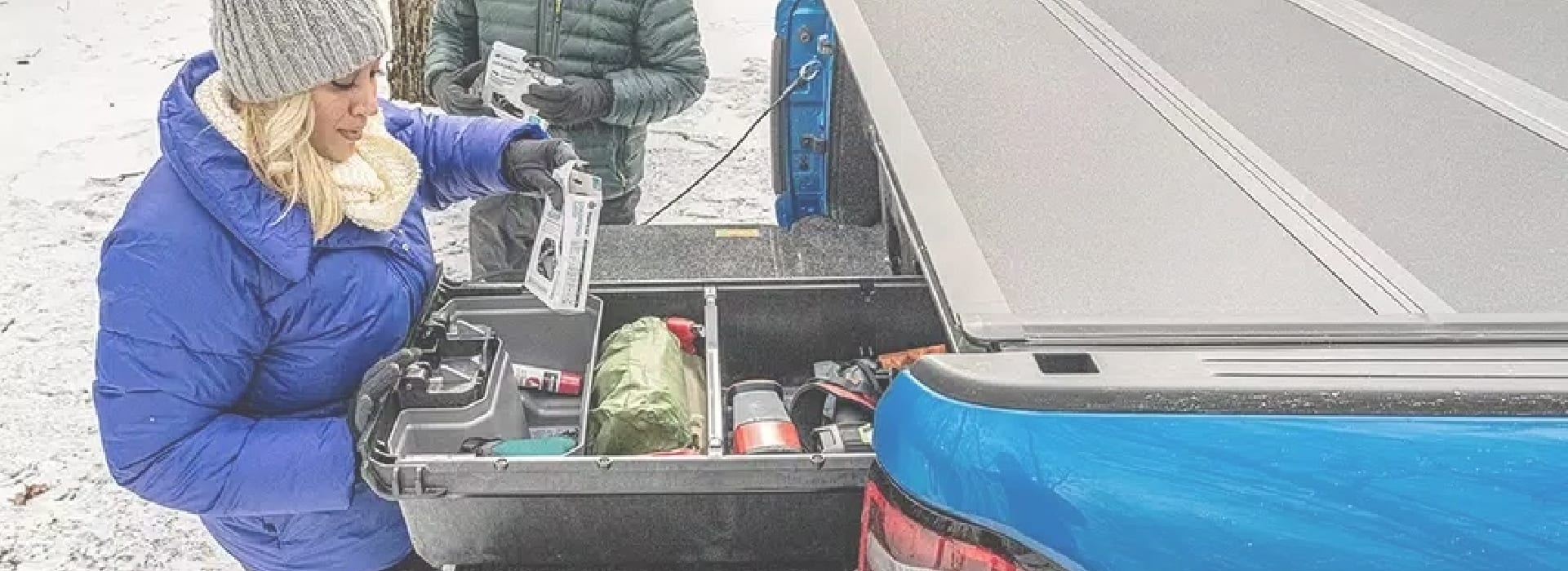 Woman accessing her gear from her Decked Drawers covered by a Bakflip Tonneau Cover