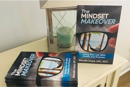The Mindset Makeover books on a nightstand.