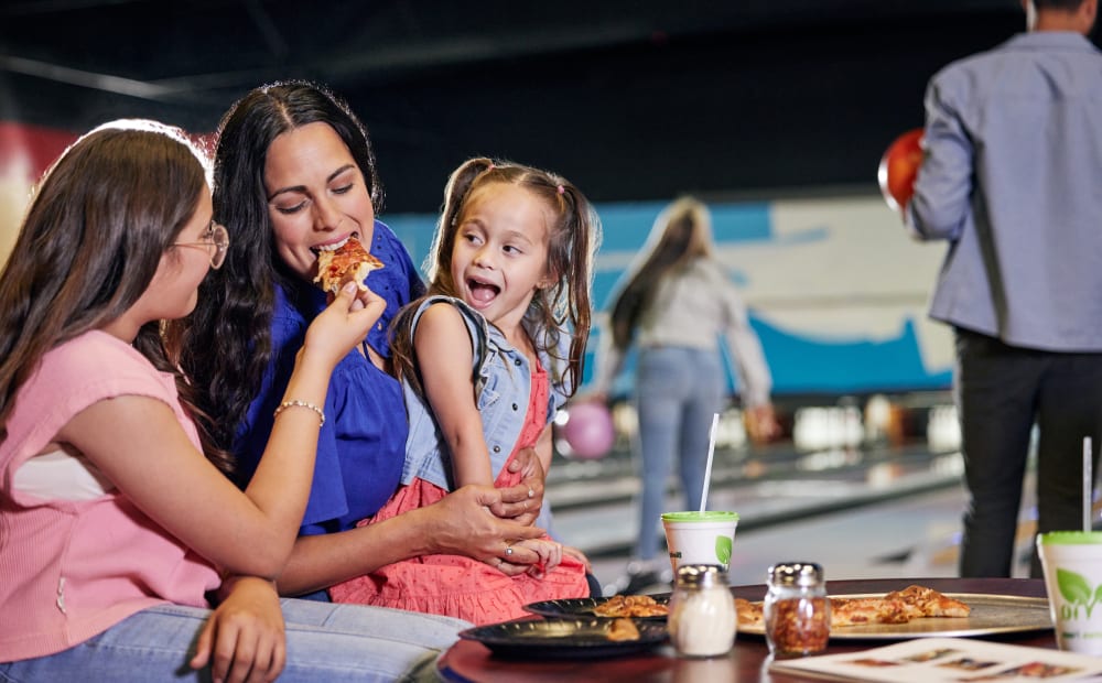 A mother and her two daughters sharing a pizza at Wild River.