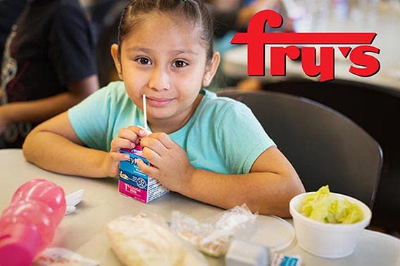 a child with a juice box and the Fry's logo