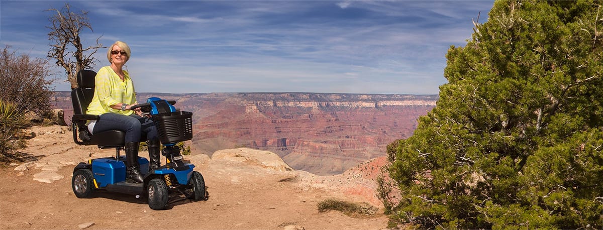 woman sitting on pride scooter at the grand-canyon